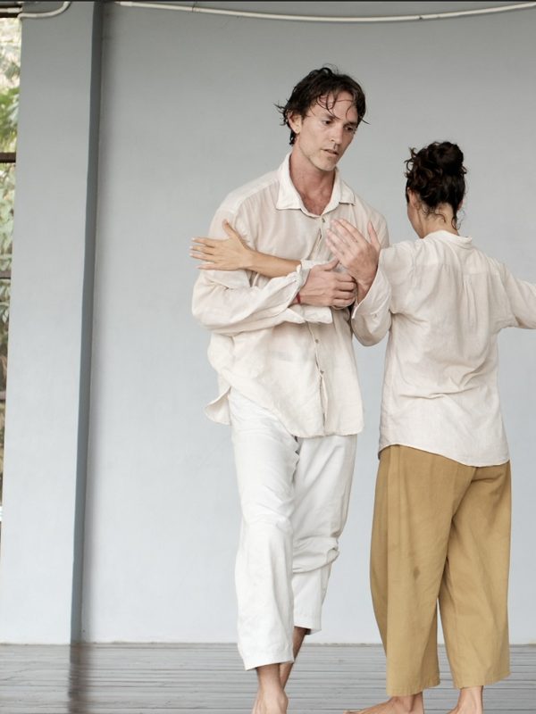Two duets standing against a grey studio wall.